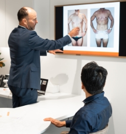 Dr Hunt with a new patient during male body contouring surgery consultation (abdominoplasty)